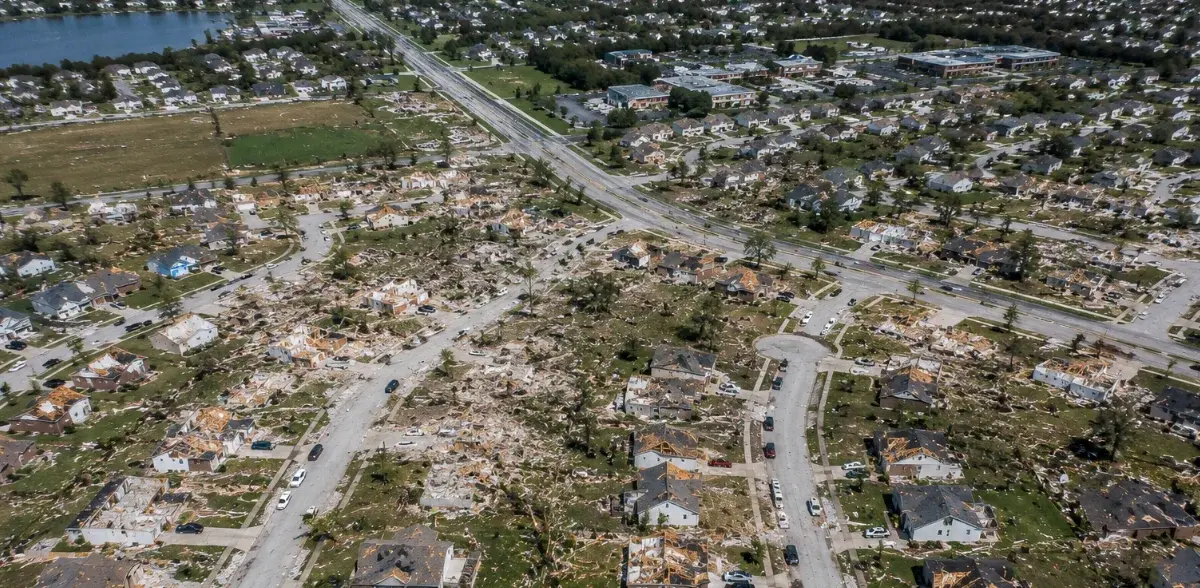 Aerial drone view showing widespread storm damage across a residential area